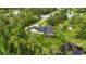 Aerial view of the home and acreage featuring a pool, outbuilding and pond at 23647 Seneca Ridge Ct, Christmas, FL 32709