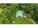 Aerial view showcases the property's expansive green building and surrounding trees at 23647 Seneca Ridge Ct, Christmas, FL 32709