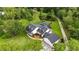 Aerial view of the home surrounded by trees with a pool and pond at 23647 Seneca Ridge Ct, Christmas, FL 32709