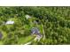 Stunning aerial view of estate home, pool, pond, and lush greenery at 23647 Seneca Ridge Ct, Christmas, FL 32709