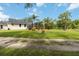 Expansive backyard featuring lush lawn and a screened-in pool enclosure, perfect for outdoor enjoyment at 23647 Seneca Ridge Ct, Christmas, FL 32709