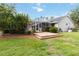 An idyllic backyard featuring a deck, screened-in porch, tropical trees, and a lush lawn at 23647 Seneca Ridge Ct, Christmas, FL 32709