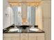Bright bathroom featuring a double vanity with granite countertops, light wood cabinets and recessed lighting at 23647 Seneca Ridge Ct, Christmas, FL 32709