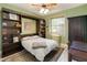 Bedroom with bed, rug, and built-in shelving at 23647 Seneca Ridge Ct, Christmas, FL 32709