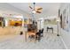 Open-concept dining area with tile flooring, modern lighting, and access to the kitchen and living spaces at 23647 Seneca Ridge Ct, Christmas, FL 32709