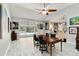 Bright and airy dining room with sliding glass doors, neutral walls, and stylish wood-look tile floors at 23647 Seneca Ridge Ct, Christmas, FL 32709