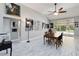 Spacious dining room with bright tile flooring and large windows that let in lots of natural light at 23647 Seneca Ridge Ct, Christmas, FL 32709