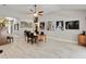 Spacious dining area featuring tile flooring and multiple pieces of artwork on the walls at 23647 Seneca Ridge Ct, Christmas, FL 32709