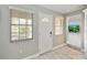 Entryway with transom window above front door and gray-tone wood-look floors at 23647 Seneca Ridge Ct, Christmas, FL 32709