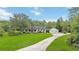 Charming two-story home with a well-manicured lawn, mature trees, and a long driveway at 23647 Seneca Ridge Ct, Christmas, FL 32709