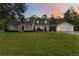Charming home featuring a lush front lawn, inviting porch, and a three-car garage at 23647 Seneca Ridge Ct, Christmas, FL 32709