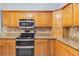 Kitchen with stainless steel appliances, granite countertops, and ample cabinet space at 23647 Seneca Ridge Ct, Christmas, FL 32709