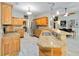 Bright kitchen with stainless steel appliances, granite counters, and breakfast bar overlooking dining area at 23647 Seneca Ridge Ct, Christmas, FL 32709