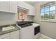 Bright laundry room with washer, dryer, sink, and window at 23647 Seneca Ridge Ct, Christmas, FL 32709