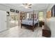 Bright main bedroom features a four-poster bed and sliding glass door to outdoor living space at 23647 Seneca Ridge Ct, Christmas, FL 32709