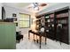 Office with built-in bookcases, a wooden desk, and light wood flooring at 23647 Seneca Ridge Ct, Christmas, FL 32709