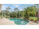 Pool with privacy landscaping and attached waterfall feature at 23647 Seneca Ridge Ct, Christmas, FL 32709