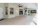 Covered porch with ceiling fans overlooking outdoor kitchen and screened pool at 23647 Seneca Ridge Ct, Christmas, FL 32709