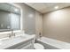 Bathroom featuring modern vanity, illuminated mirror, and tiled shower/bath at 2627 Oak Park Way # 102, Orlando, FL 32822