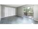 Bedroom featuring gray tile flooring, closet, and sliding glass door to patio at 2627 Oak Park Way # 102, Orlando, FL 32822