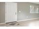 Apartment entryway showcasing a neutral wall color, front door, and patterned flooring at 2627 Oak Park Way # 102, Orlando, FL 32822