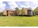 Exterior view of the apartment building with well-manicured lawn at 2627 Oak Park Way # 102, Orlando, FL 32822