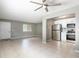 Living area and kitchen showcasing stainless appliances, gray paint, and natural lighting at 2627 Oak Park Way # 102, Orlando, FL 32822