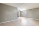 A vacant living area with tile floors, a window for natural light, and neutral gray paint at 2627 Oak Park Way # 102, Orlando, FL 32822