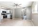 Living and dining area with kitchen view featuring tile floors and a ceiling fan at 2627 Oak Park Way # 102, Orlando, FL 32822