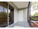 Enclosed patio with tiled floor and view of lush greenery at 2627 Oak Park Way # 102, Orlando, FL 32822