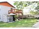 Serene backyard with upper deck, grilling area, fenced perimeter, and well-kept lawn at 312 W Hull Ave, Oakland, FL 34760