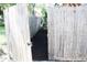 Backyard gate leading to a garden area with fresh mulch at 312 W Hull Ave, Oakland, FL 34760