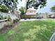 Expansive backyard with a fenced perimeter and a paved patio area perfect for outdoor entertaining at 312 W Hull Ave, Oakland, FL 34760