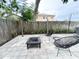 Charming backyard patio with modern seating, a fire pit, and lush greenery for relaxation at 312 W Hull Ave, Oakland, FL 34760