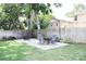 Inviting backyard patio with outdoor dining set, modern chairs, and lush surroundings at 312 W Hull Ave, Oakland, FL 34760
