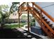 Inviting backyard features stairs to deck and patio area with stylish furniture at 312 W Hull Ave, Oakland, FL 34760