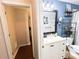 Clean bathroom with blue walls, black fixtures, and modern shelving at 312 W Hull Ave, Oakland, FL 34760