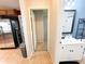 Bright bathroom featuring a white vanity with black hardware and a framed mirror at 312 W Hull Ave, Oakland, FL 34760