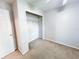 Clean bedroom featuring a carpeted floor, closet and white door at 312 W Hull Ave, Oakland, FL 34760