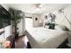 Comfortable bedroom with ceiling fan, dark wood floors, and a palm tree theme at 312 W Hull Ave, Oakland, FL 34760