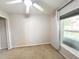 Neutral bedroom with a ceiling fan, carpeted floor, and a window view to the outside at 312 W Hull Ave, Oakland, FL 34760