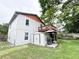 Exterior side view showcases the home's well-maintained yard and shed at 312 W Hull Ave, Oakland, FL 34760