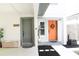 Charming home exterior showcasing a gray and an orange front door with a small garden at 312 W Hull Ave, Oakland, FL 34760