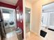 Hallway with entrances to bathroom and laundry room, connecting to the kitchen area at 312 W Hull Ave, Oakland, FL 34760