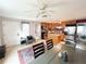 Eat-in kitchen with stainless steel appliances, an island, and an adjacent dining area at 312 W Hull Ave, Oakland, FL 34760