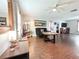 Spacious living room featuring hardwood floors, modern lighting, and ample natural light at 312 W Hull Ave, Oakland, FL 34760