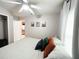 Bedroom featuring neutral tones, soft lighting, and views into the kitchen at 312 W Hull Ave, Oakland, FL 34760