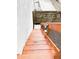 Wooden outdoor stairs lead down to a meticulously maintained yard area at 312 W Hull Ave, Oakland, FL 34760