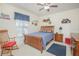A stylish bedroom featuring a wood bed frame, playful décor, and ample natural light at 3231 Furlong Way, Gotha, FL 34734