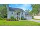 Beautiful two-story home features a well-kept lawn, a three-car garage, and neatly trimmed landscaping at 3231 Furlong Way, Gotha, FL 34734